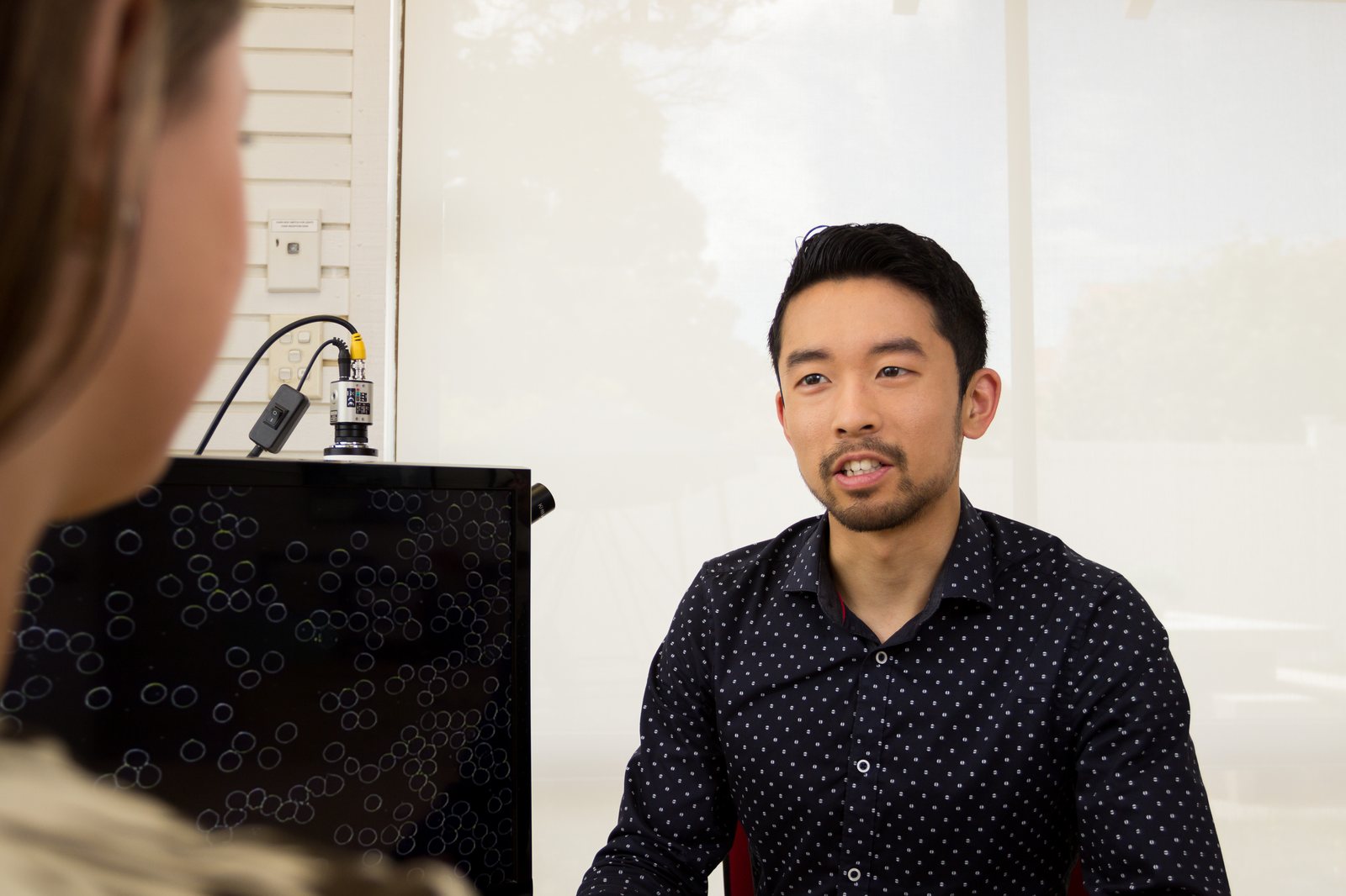 Kohei Iguchi performing live blood analysis at Waterwell Clinic