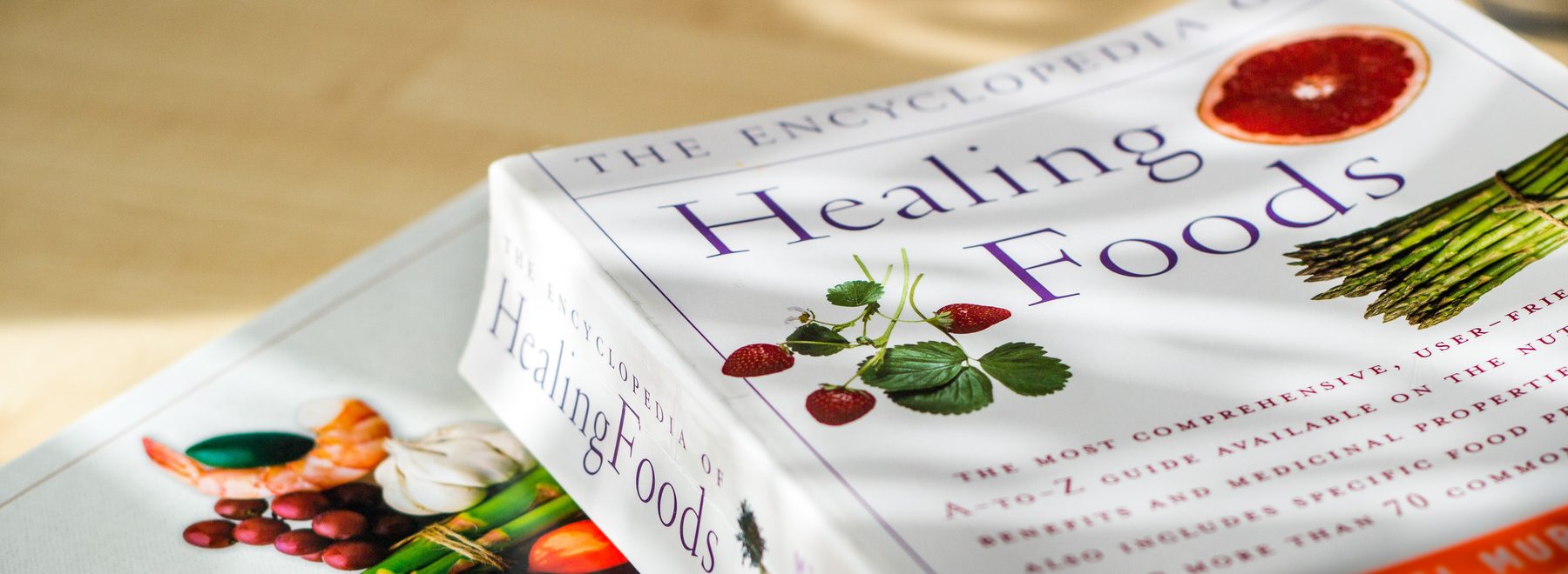 Reference books on nutrition and healing foods on Kohei's desk